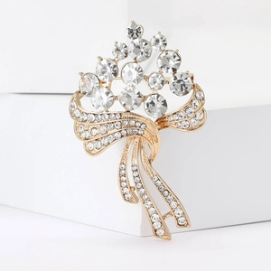 Vue macro de broche florale dorée avec grands cristaux et détails micro-pave fins