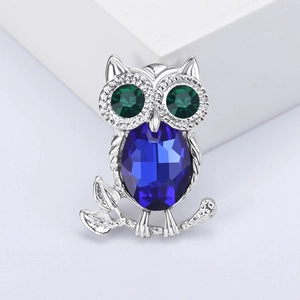 Exquisite silver owl brooch with blue oval faceted crystal and green rhinestone eyes
