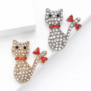 Exquisite hollow cat brooches with crystals and bow detail on geometric stands
