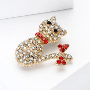 Detailed macro view of the cat brooch featuring sparkling crystals and a red bow decoration