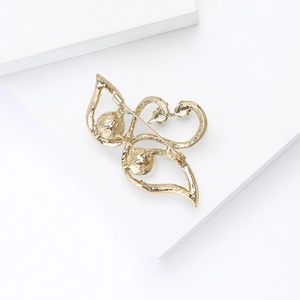 Detail of elegant swan brooch back showing golden metal pin closure and hollow design