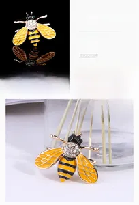 Detailed close-up of a bee brooch with yellow enamel wings and sparkling rhinestones