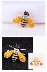Detail view of mini bee brooch with yellow enamel, crystals and needle clasp back