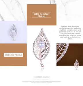 Detail of hollow leaf brooch with sparkling crystals and a central white round pearl