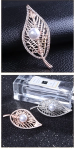 Detailed close-up of leaf brooch with hollow veins, inlaid rhinestones and central pearl