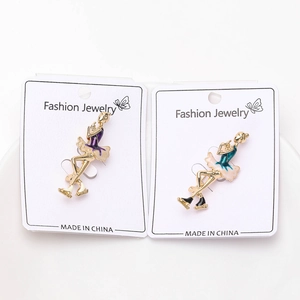 Detailed view of alloy enamel gymnast brooches on fashion jewelry display card