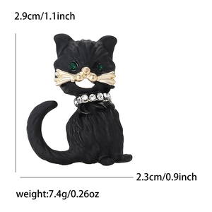Cute black enamel cat brooch with green rhinestone eyes and sparkling collar on white background