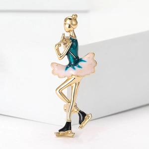 Detailed macro of enamel rhythmic gymnastics girl brooch with pink skirt and golden metal