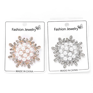 Macro shot of snowflake brooches with pearls and crystals on jewelry display cards