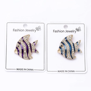 Detail of coral fish brooches with colorful enamel finish and crystal rhinestones