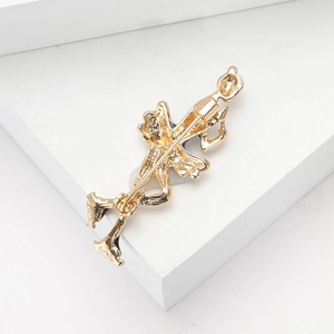 Detail view of the secure safety pin back on a gold-tone gymnast enamel brooch