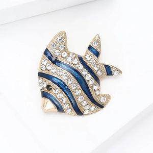 Close-up of a tropical angel fish brooch with blue enamel and sparkling rhinestones