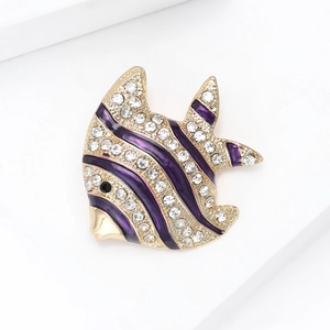Detail of a tropical fish brooch with purple enamel and white sparkling crystals