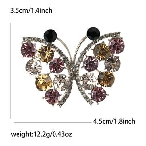 Silver butterfly brooch with purple and brown rhinestones measuring 4.5cm by 3.5cm