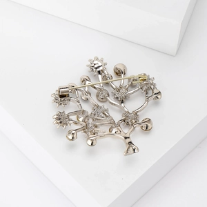 Silver tree-shaped alloy brooch with sparkling rhinestones and secure back pin closure