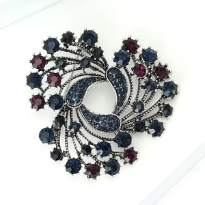 Close-up of vintage Christmas alloy brooch with blue and purple crystal rhinestones