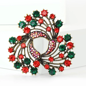 Macro detail of vintage Christmas bell brooch with red and green rhinestones