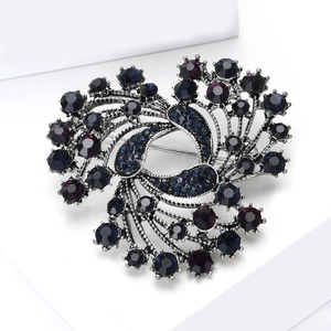 Macro view of a vintage flower brooch with dark alloys and deep purple crystals