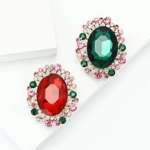 Elegant vintage oval brooch with emerald green and ruby red stones surrounded by crystals