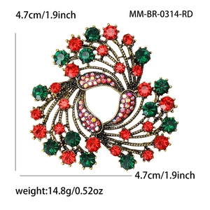Vintage round Christmas brooch with red and green rhinestones in an ornate bronze setting