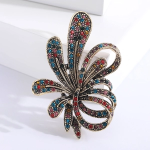 Macro detail of luxury flower brooch with colorful rhinestones on antique gold base