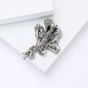 Detail view of the vintage gun-black orchid brooch back with secure rotary pin safety clasp