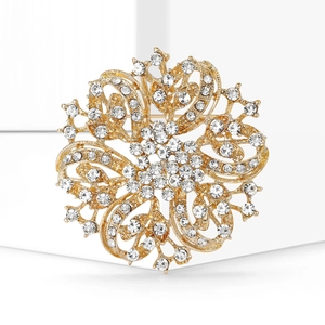Detailed macro view of luxury gold floral brooch with sparkling crystal rhinestones