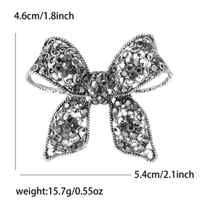 Vintage alloy bow brooch with rhinestones and hollow floral patterns, size 5.4cm x 4.6cm