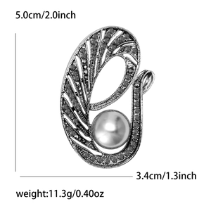 Broche vintage en bronze avec perle et strass noirs au design creux incurvé