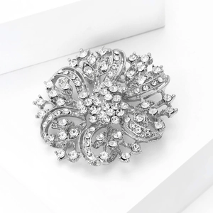 Macro shot of sparkling crystal flower brooch with silver metal filigree and rhinestones