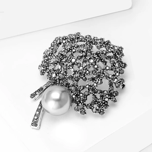 Vintage floral brooch with black crystals, hollow alloy petals and a grey pearl accent