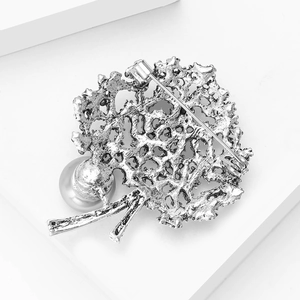 Detailed back view of vintage hollow tree brooch with silver alloy and large grey pearl