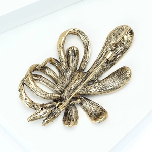 Detailed back view of vintage gold floral brooch showing secure safety pin and clasp