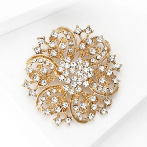 Macro detail of luxury floral alloy brooch featuring intricate gold metalwork and clear rhinestones