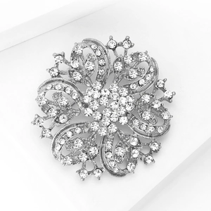 Macro shot of silver crystal flower brooch with detailed rhinestones and petal textures