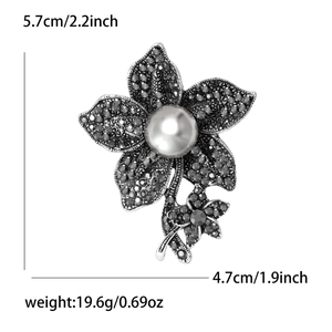 Detail view of retro flower brooch with black rhinestones and pearl showing dimensions