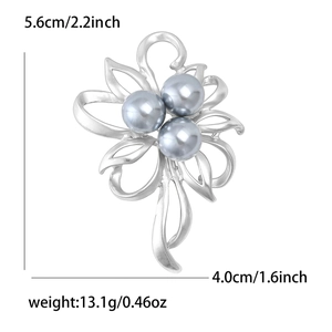 Detailed view of silver matte flower brooch with grey pearls and 5.6cm height mark