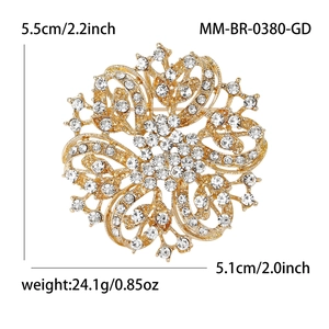 Luxurious gold flower brooch with sparkling crystals and victorian filigree pattern