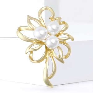 Elegant matte gold flower brooch with white pearls for women on white display stands