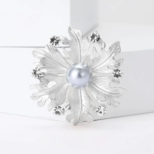 Elegant silver matte flower brooch with central grey pearl and sparkling rhinestones