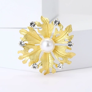 Elegant gold flower brooch with central white pearl and sparkling rhinestones for suits