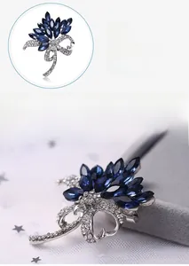 Detailed macro view of dark blue floral crystal brooch with silver alloy and small diamonds