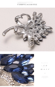 Detail view of silver brooch with dark blue marquise gems and small crystal rhinestones
