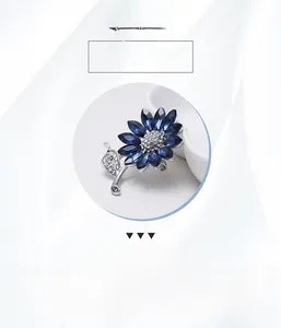 Detailed view of sunflower brooch with deep blue crystal petals and silver alloy base