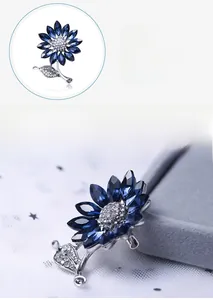 Detail view of sunflower brooch with dark blue crystal petals and silver alloy stem