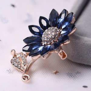 Sunflower brooch with deep blue crystal petals and rose gold alloy setting