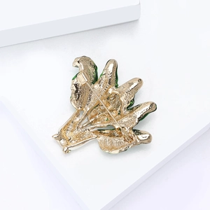 Macro detail of the back structure and safety pin of the green enamel cabbage brooch
