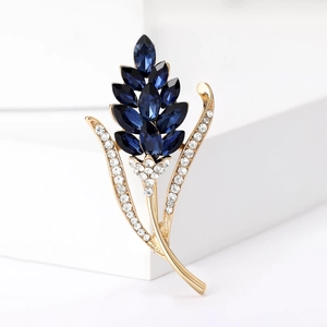 Elegante Ährenbrosche mit dunkelblauen Kristallen und vergoldeten Metalldetails