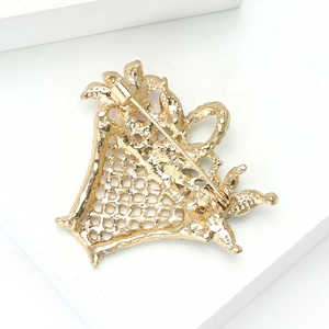 Detail view of the intricate hollow back and secure metal pin on the golden flower brooch
