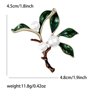 Elegant dark green leaf brooch with white pearls and branch detailing shown in full size